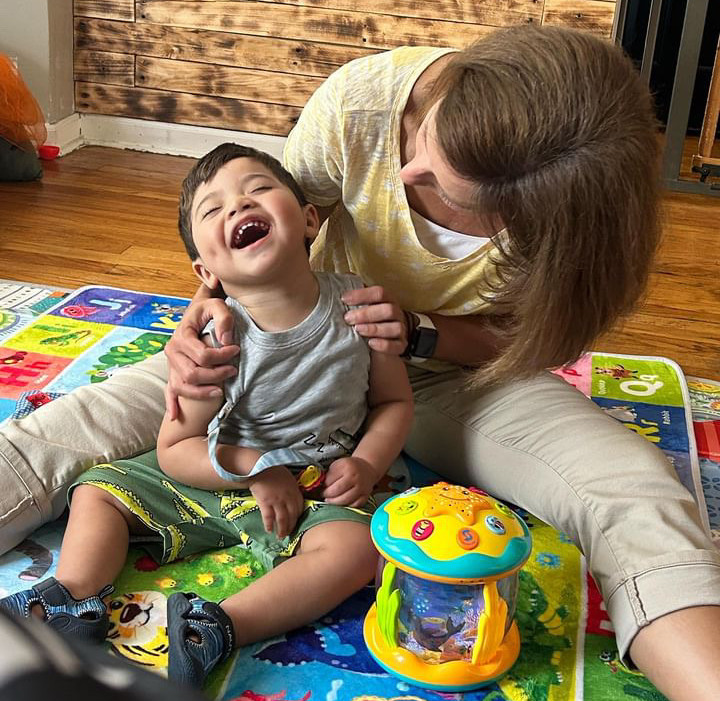 Special needs child with therapist, laughing